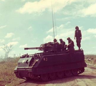 An M-163 Vulcan fires into the brush to flush out enemy troops along Highway 13 in Vietnam.