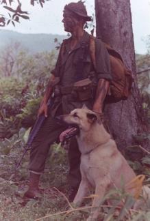 Lance Corporal Ralph McWilliams stands with his scout dog "Major".