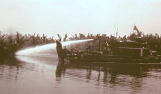 Douche boats, Armored Troop Carriers (ATC) converted to carry a water cannon, were capable of washing away the enemy riverbank mud bunkers, which would stand up to howitzer fire.