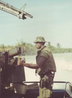 SKSN Ellis Manns of the 549th River Division stands by his 50 cal.