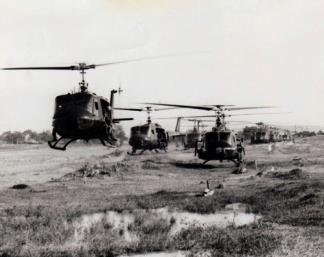 UH-1D helicopters, carrying members of the of the 3rd Battalion, 8th Infantry, 4th Infantry Division, lift off from Camp Radcliff for a combat assault.