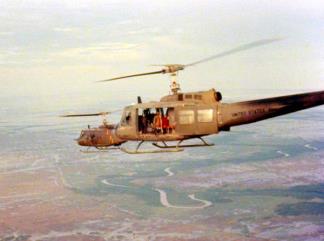 Two UH-1 'Slick' Helicopters flying over the Mekong Delta.