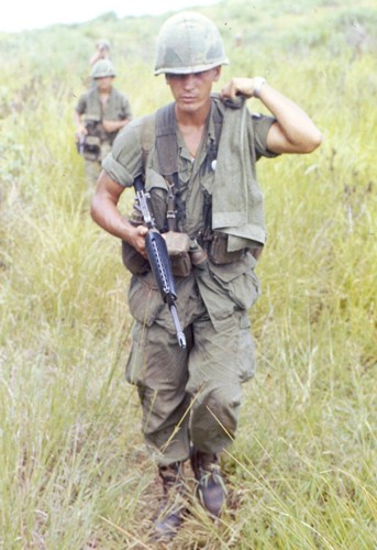 A member of the 101st Airborne uses an olive green towel as a sweat scarf whilst on patrol during Operation Wheeler.