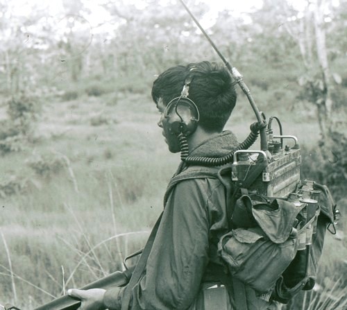 A Radio Telephone Operator (RTO) of the 101st Airborne wears a PRC-25 radio headset whilst on patrol.
