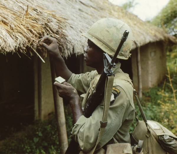 A member of the 101st Airborne on Operation Van Buren sets fire to a village hut containing Viet Cong rice stocks.