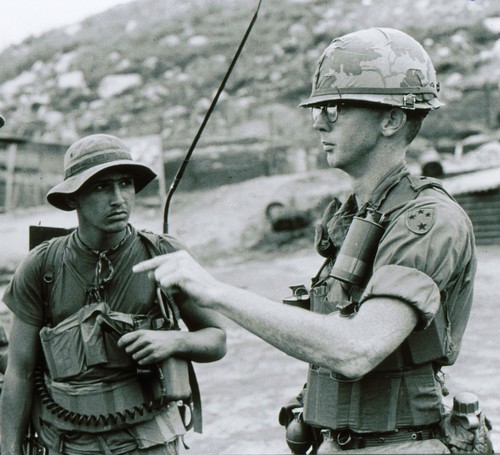 A Captain and Radio Telephone Operator (RTO) of the 21st Infantry, 11th Infantry Brigade (Light) prepare to go on patrol.
