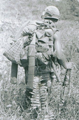 A soldier of the 5th Battalion, 46th Infantry, 198th Light Infantry Brigade uses a boot sock to carry his C-Ration cans whilst on an operation west of Chu Lai (I Corps).
