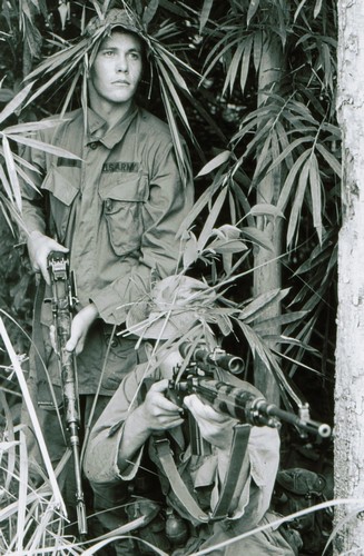 Snipers of Bravo Company, 2nd Battalion, 18th Infantry, 1st Infantry Division, take up a position armed with accurized and camouflaged M14 rifles.