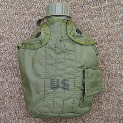 The M1967 nylon 1-Quart Canteen Cover had plastic snap fasteners and a Velcro sealed pocket for water purification tablets.