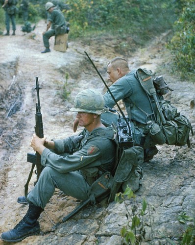 A 1st Infantry Division Captain and his Radio Telephone Operator (RTO) take  a break from a Search and Destroy operation near Bien Hoa (III Corps).