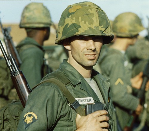 A Specialist 5th Class of the 25th Infantry Division wears a brand new Mitchell Pattern helmet cover on  arrival at Pleiku airstrip (Central Highlands - II Corps) in December 1965.