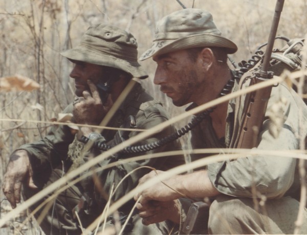 A Platoon Sergeant and Radio Telephone Operator (RTO) of 8th Platoon, 'C' Company, 7 RAR, pause during an ambush patrol in the Nui Thi Vai hills.