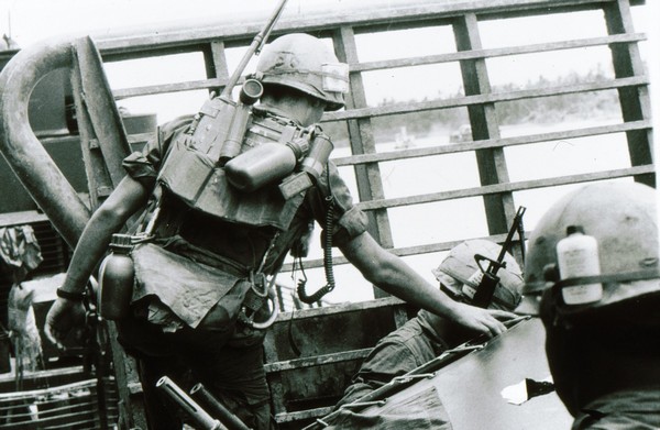 A Radio Telephone Operator (RTO) of the 47th Infantry, 9th Infantry Division aboard an Armored Troop Carrier (ATC) near Thoi Tan Island.