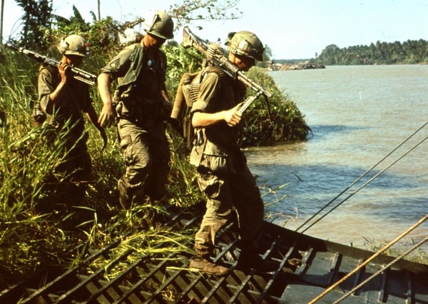 M60 gunners of the 47th Infantry, 9th Infantry Division board a Navy armored troop carrier (ATC) after a Search and Destroy operation.