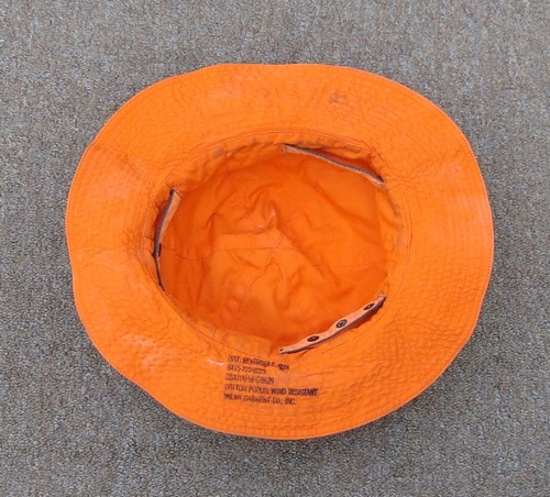 The two color (Olive Green and Orange) Reversible Sun Hat featured a size adjustment strap that was laced through slits at the base of the crown.