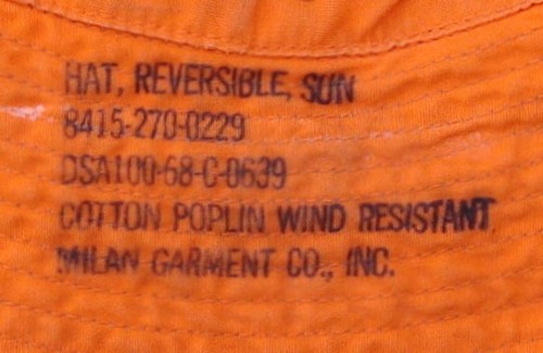 The nomenclature and contract information was stamped on the orange side of the Reversible Sun Hat.