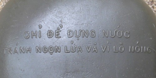 The 'Do Not Apply Canteen To Open Flame Or Burner Plates' warning message on the ARVN canteen was printed in Vietnamese.