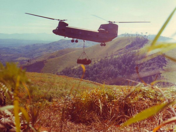 A CH-47 Chinook sling lifts supplies for members of Co A, 1st Bn, 8th Inf, 4th Inf Div, on the side of Hill 1049, approximately 8km southeast of Dak To in the Central Highlands.