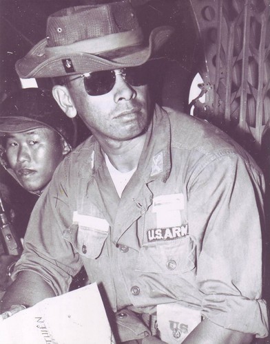 Captain David Helela, MAAG Advisor, with members of the Vietnamese 21st Division aboard a CH-21 helicopter travelling to a combat drop zone.