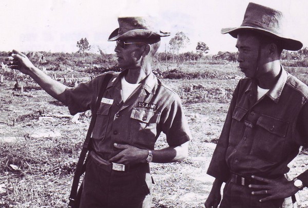 MAAG Advisor Captain William Johnston discusses the defense of outpost Ly Van Manh with Captain Tran Tien Khang, CO of the 1st Bn.