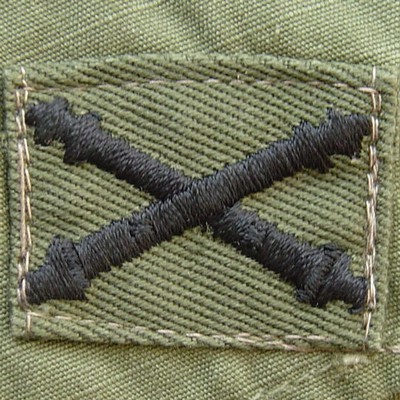 Subdued version of the Field Artillery Branch of Service Insignia.