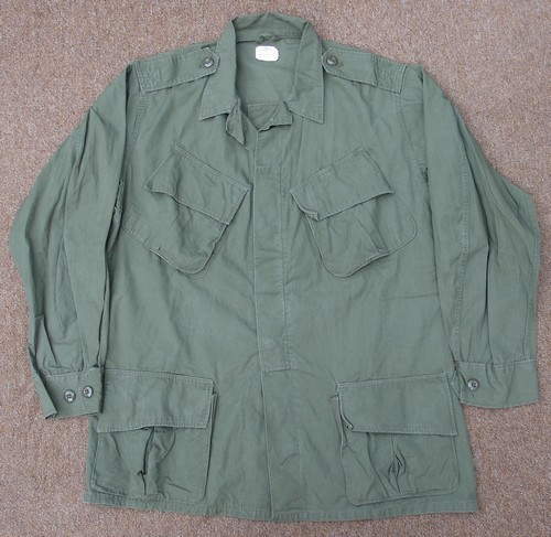 The 2nd pattern Tropical Combat Jacket featured concealed cargo pocket buttons, but retained the original epaulets (shoulder loops) and gas flap.