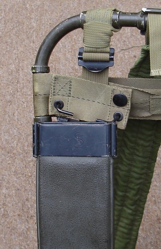 The Lightweight Rucksack's upper horizontal strap boasted a pair of hinged double eyelet webbing hangers that were designed to accommodate machete sheaths.