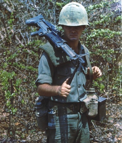 A machine gunner of the 2nd Battalion, 28th Infantry, 1st Infantry Division uses an olive green towel to pad his shoulder against the weight of his M60.