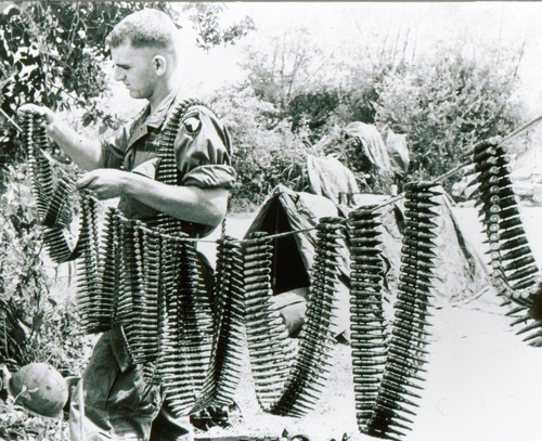 A machine-gunner of 101st Airborne dries his ammunition after heavy rain during Operation Wheeler, near Chu Lai.