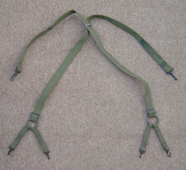 Marines often used grenade rings to keep to the cross of the M1941 suspenders in place.