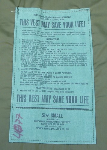 The large instruction and nomenclature label of the Velcro fastening 122 series M69 vest was used as a pocket for the care and use manual.