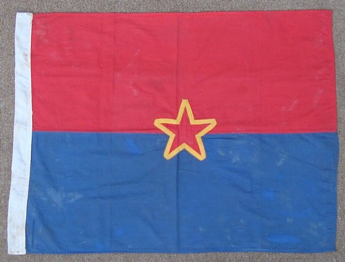A captured NLF / VC flag with a traditional Communist red star.