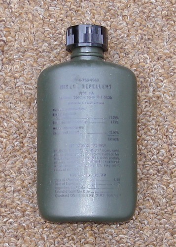 A 1969 dated olive drab bottle of liquid DEET.