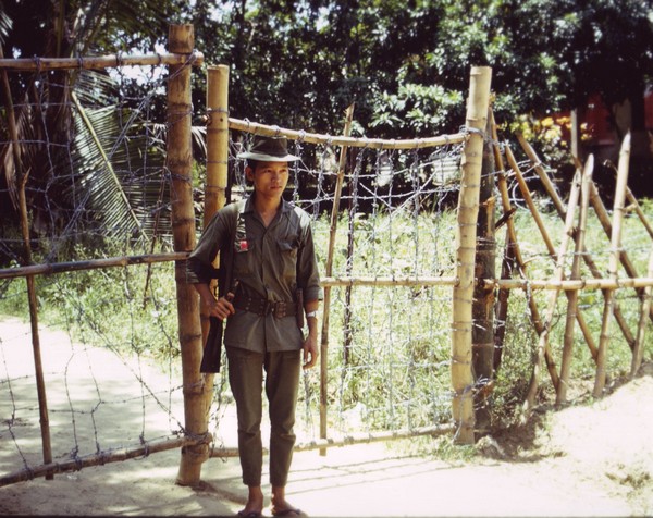 A young soldier from the South Vietnamese Popular Forces stands guard duty.