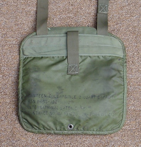 The first 2-quart canteen cover issued to Special Forces in Vietnam was made by the International Latex Corporation and had a 2-inch wide webbing reinforcement strip across the back.