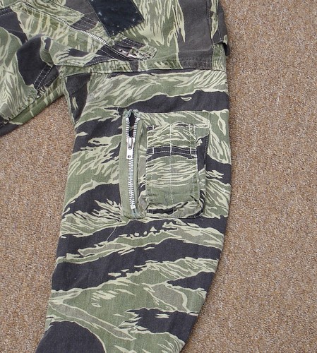 A small pocket (with outside pen holder) is located on the left shoulder of this Tiger Stripe flight suit.