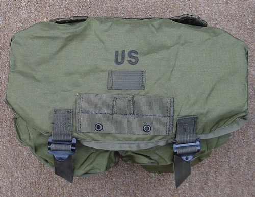 The top flap of the M-1967 USMC nylon combat field pack boasted a hanger for attaching an intrenching tool cover.