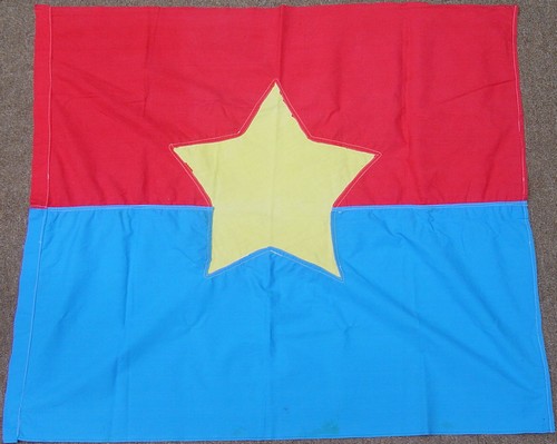 A captured NLF / Viet Cong flag with a yellow Communist star.