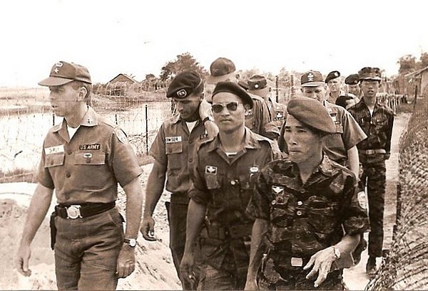 Captain William Bowser, commander of Special Forces detachment A-422, conducts a tour of the Vinh Gia camp for Brigadier General William DePuy (left), MACV J-3 (Director of Operations), Major Thuong, IV Corps Commander of Vietnamese Special Forces (LLDB), and LLDB Commander General Doan Van Quang (right).