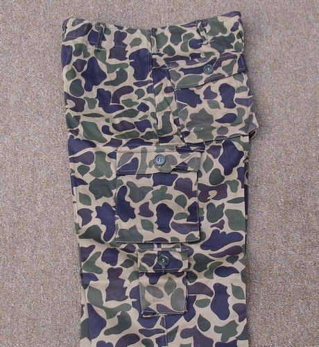 Leaf camouflage trousers featuring 2 exposed button hip pockets, two exposed button thigh cargo pockets and a small first aid pocket on the left leg.