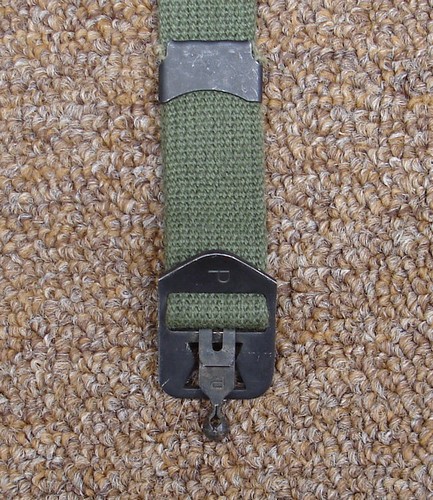 The M1 helmet webbing chinstrap was fastened with a ball-hook closure.
