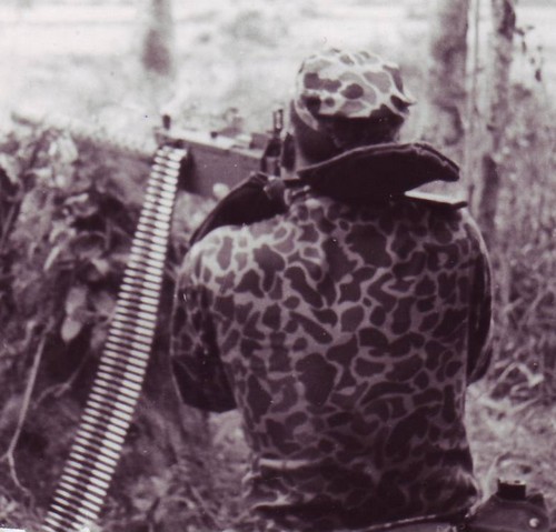 A Special Forces machine gunner fires a Browning M1919 at a group of Viet Cong insurgents on the edge of the Ap Suoi Tre rubber plantation in war zone D, north of Ben Cat (III Corps).