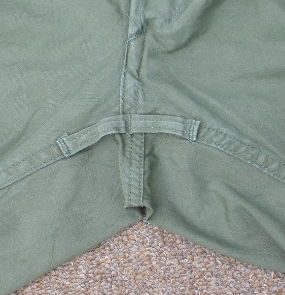 The 1st and 2nd versions of the Tropical Combat Trousers were equipped with loops through which the cargo pocket leg ties were passed.