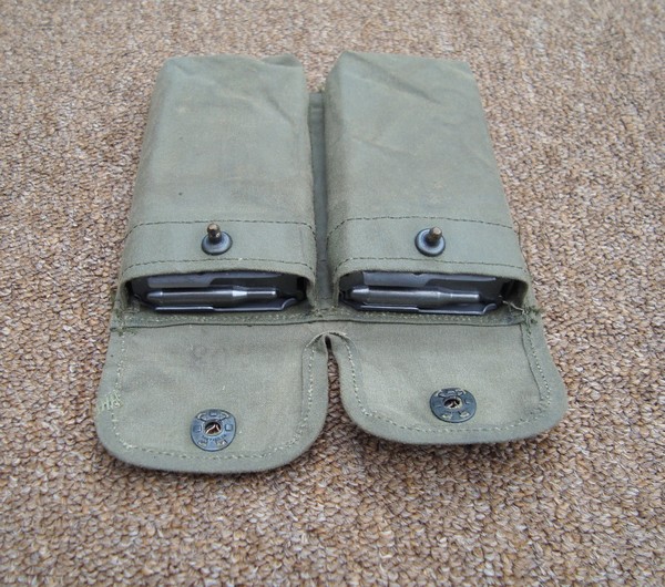 The M16 pouch had two separate pockets, each of which could accommodate a single 20-round magazine, and was closed with a lift-the-dot fastener.